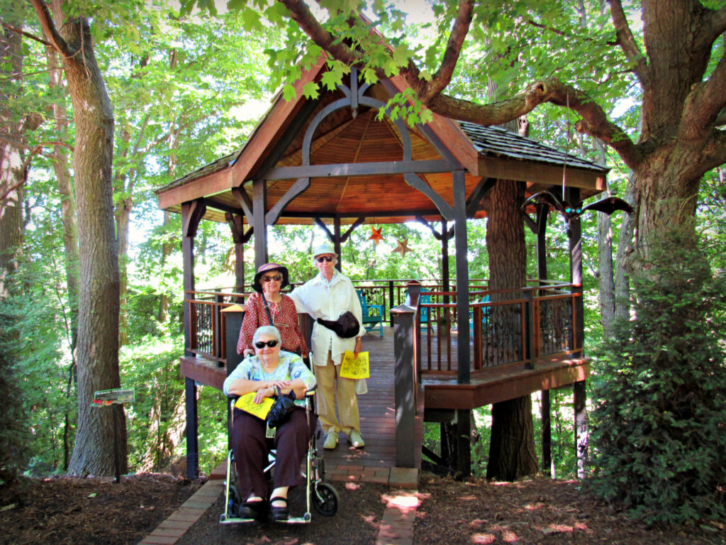 Elderly adults posing for photo at Treehouse, Bookworm Gardens