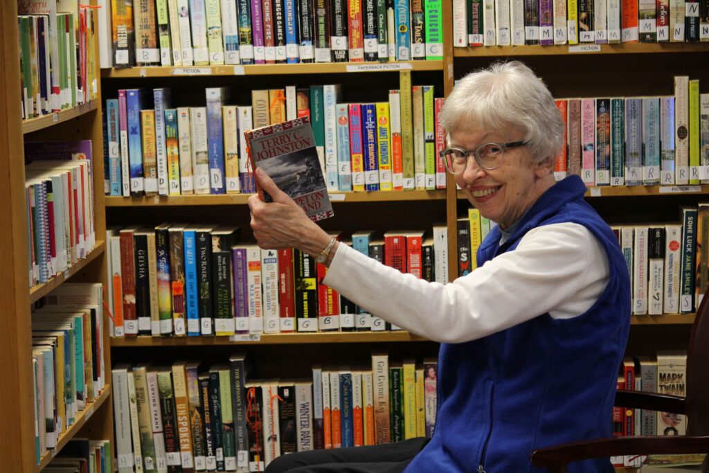 senior woman choosing a book