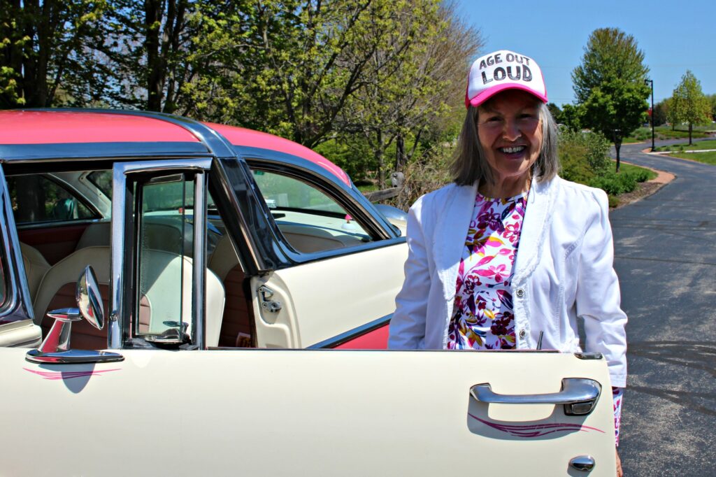 Elderly woman with vintage car