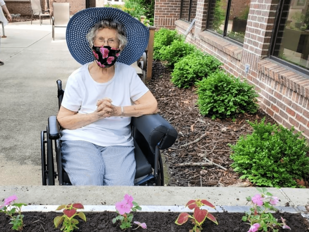 Elderly woman planting flowers