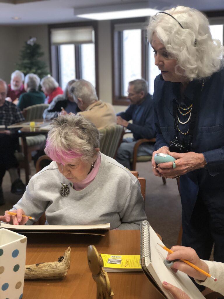 Independent living residents volunteer to help share their skills in a drawing class