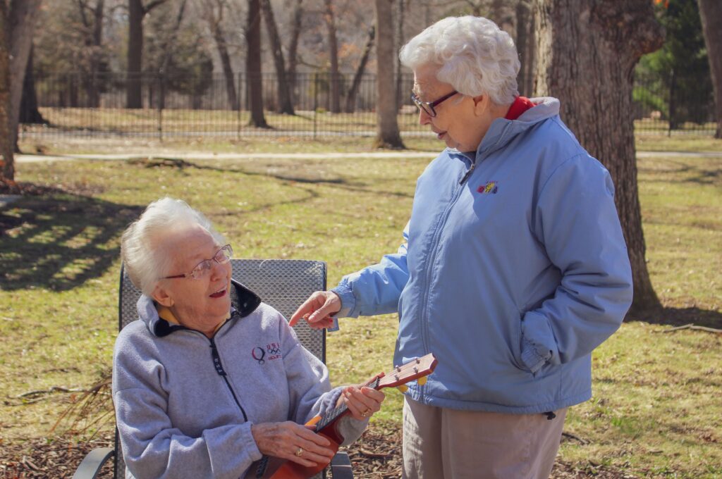 Two older adult women having conversation outdoors